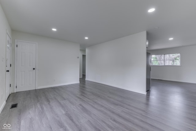 unfurnished room with recessed lighting, baseboards, visible vents, and wood finished floors