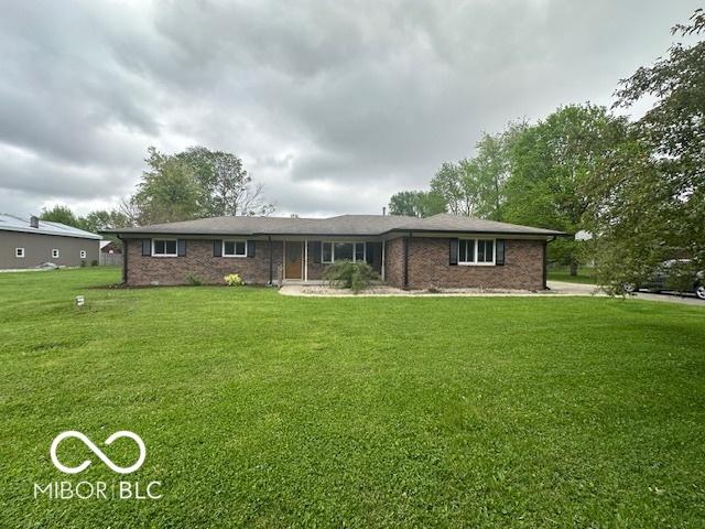 ranch-style house with a front lawn and brick siding