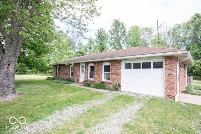 5340 N State Highway 7, North Vernon, IN 47265 - ranch-style house featuring driveway, an attached garage, brick siding, and a front yard