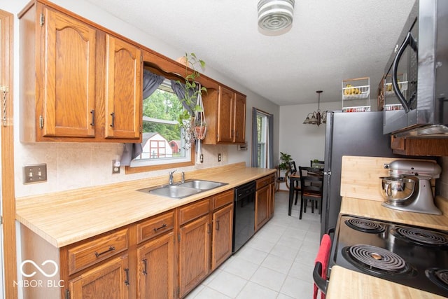 5340 N State Highway 7, North Vernon, IN 47265 - kitchen featuring black appliances, a sink, light countertops, light tile patterned flooring, and brown cabinetry