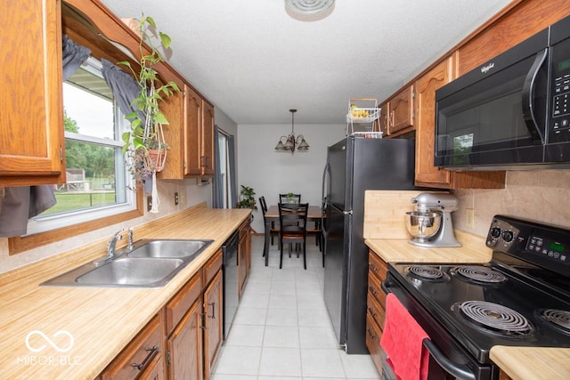 5340 N State Highway 7, North Vernon, IN 47265 - kitchen with black appliances, a sink, light countertops, and brown cabinetry