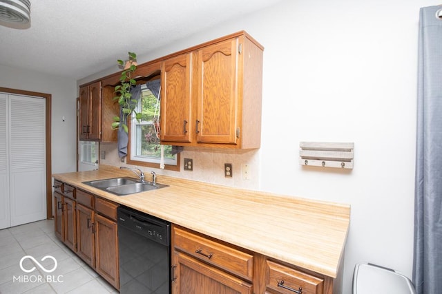 5340 N State Highway 7, North Vernon, IN 47265 - kitchen with dishwasher, a sink, light tile patterned floors, light countertops, and brown cabinetry