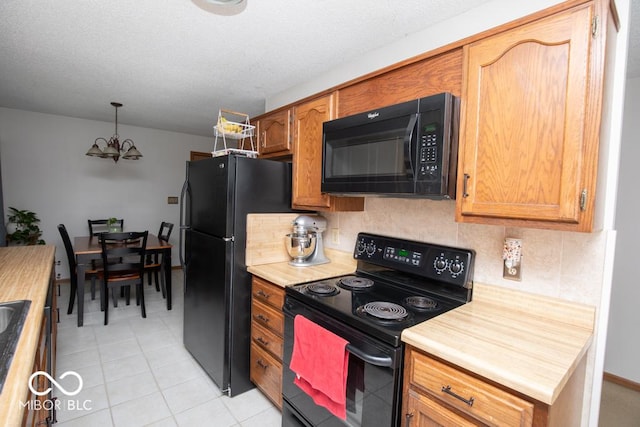 5340 N State Highway 7, North Vernon, IN 47265 - kitchen featuring black appliances, decorative backsplash, light countertops, and decorative light fixtures