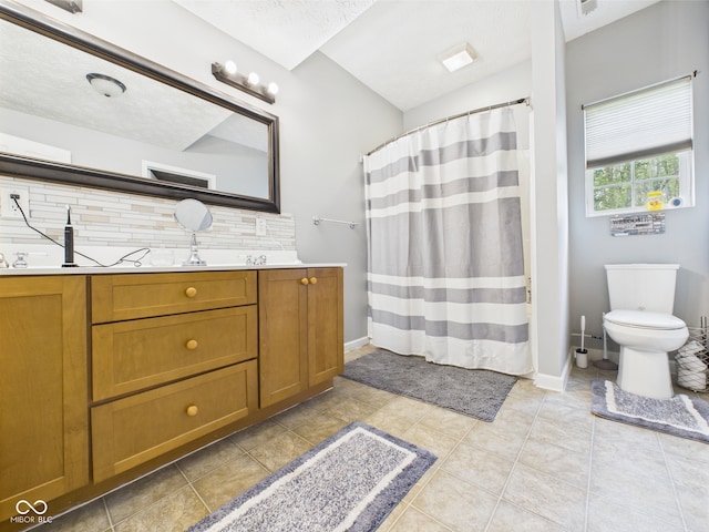 full bathroom featuring vanity, toilet, baseboards, tile patterned floors, and backsplash