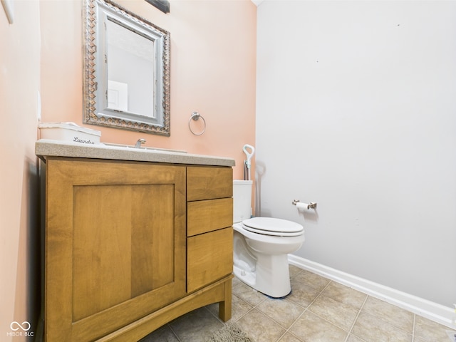 bathroom featuring toilet, baseboards, tile patterned flooring, and vanity