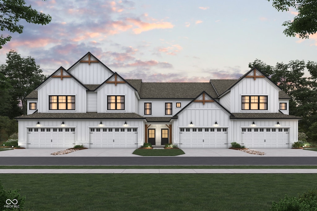 view of front of property with board and batten siding, concrete driveway, and a front lawn