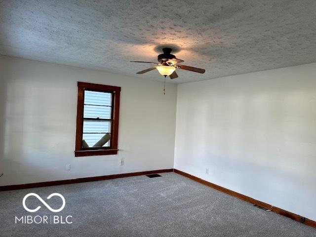 1045 13th St, Tell City, IN 47586 - unfurnished room with ceiling fan, carpet flooring, a textured ceiling, and baseboards