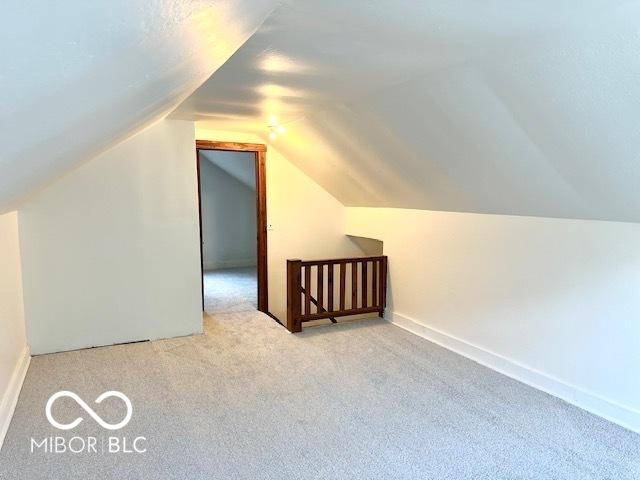 1045 13th St, Tell City, IN 47586 - additional living space featuring carpet floors, lofted ceiling, and baseboards