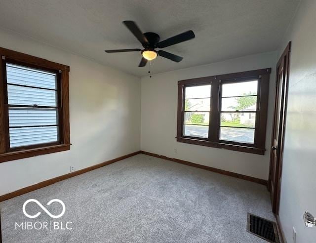 1045 13th St, Tell City, IN 47586 - carpeted empty room with plenty of natural light, ceiling fan, and baseboards