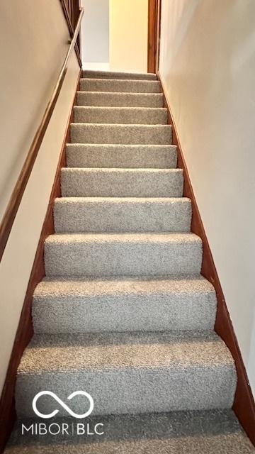 1045 13th St, Tell City, IN 47586 - staircase featuring carpet floors