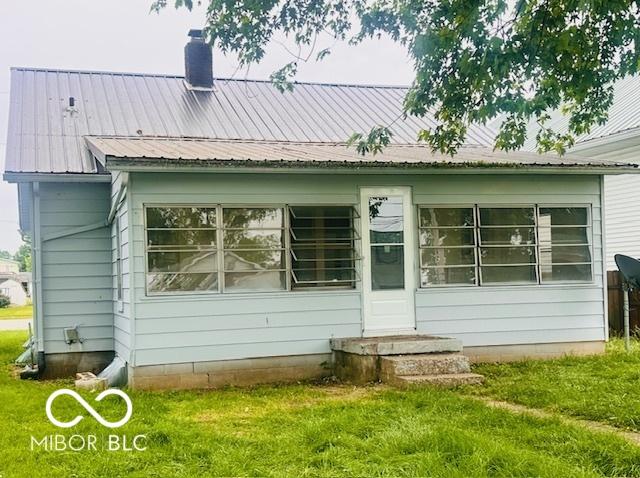 1045 13th St, Tell City, IN 47586 - rear view of property with a yard, a chimney, and metal roof