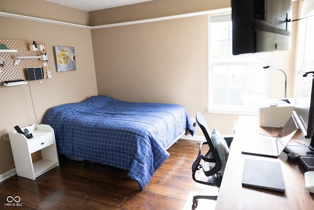 bedroom with baseboards and wood finished floors