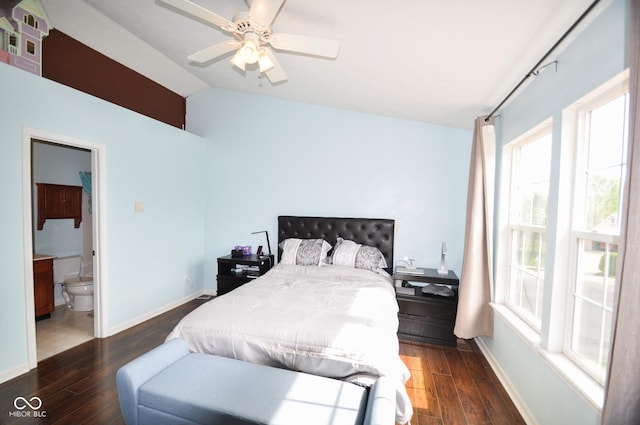 bedroom with ensuite bath, a ceiling fan, baseboards, wood finished floors, and lofted ceiling