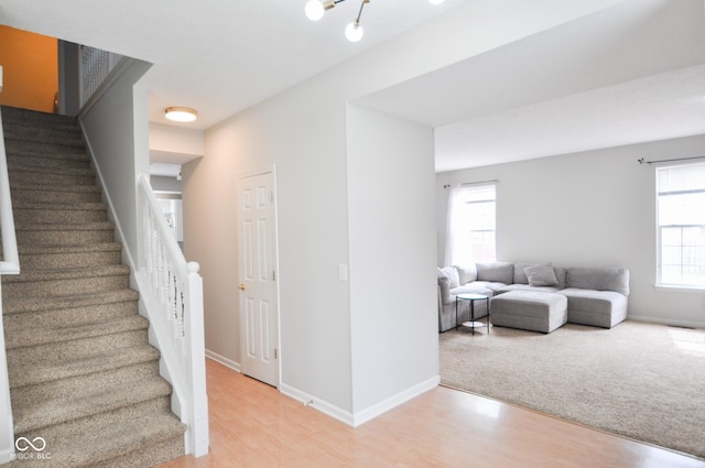 staircase featuring baseboards and wood finished floors