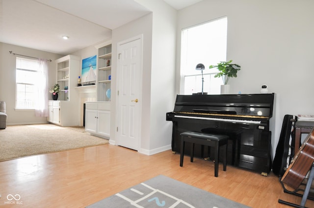 living area with baseboards and wood finished floors