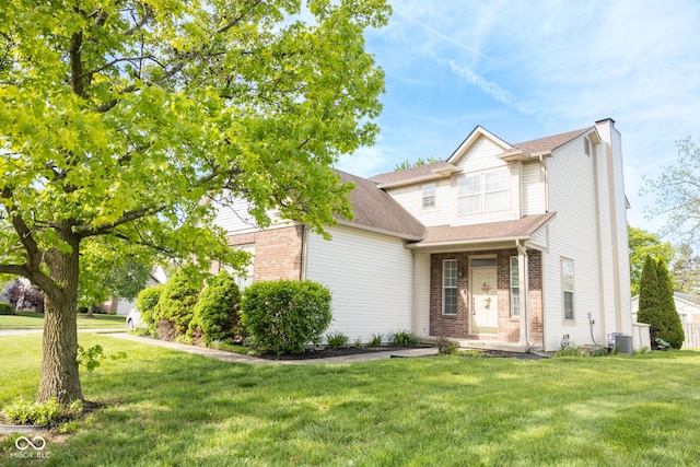 9718 Jupiter Pass, Carmel, IN 46032 - view of front of property featuring brick siding, a chimney, central air condition unit, and a front lawn
