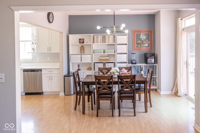 9718 Jupiter Pass, Carmel, IN 46032 - dining room with light wood-style flooring, a chandelier, and baseboards