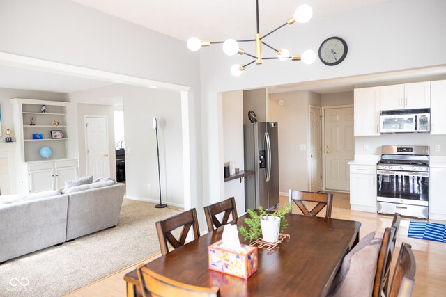 9718 Jupiter Pass, Carmel, IN 46032 - dining room featuring a chandelier and light wood finished floors