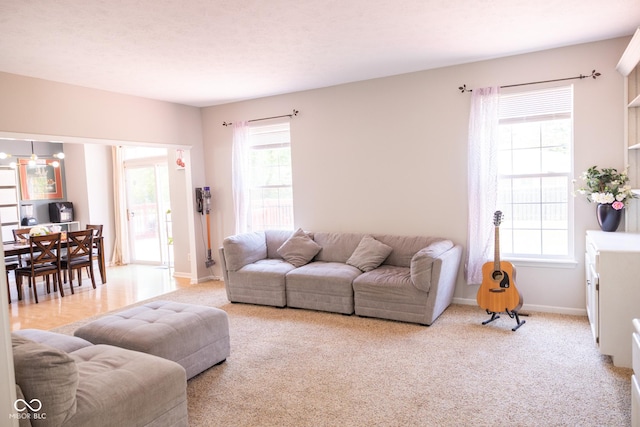 9718 Jupiter Pass, Carmel, IN 46032 - living room featuring plenty of natural light, baseboards, and light carpet