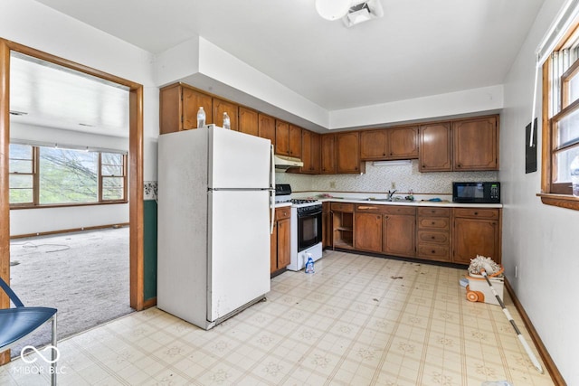 3200 Raible Ave, Anderson, IN 46011 - kitchen featuring freestanding refrigerator, light floors, light countertops, gas stove, and black microwave