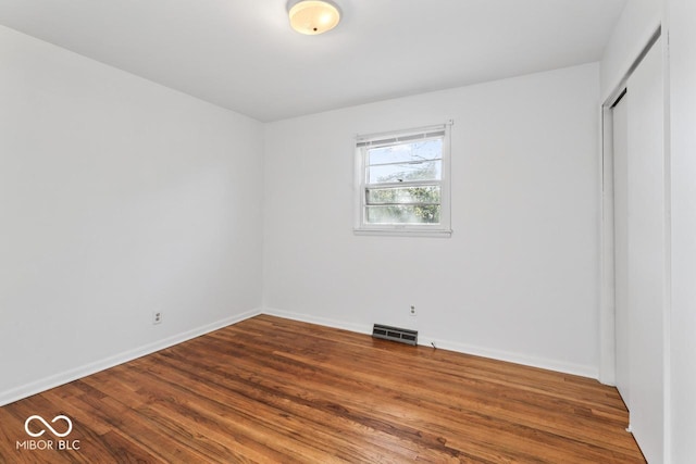 3200 Raible Ave, Anderson, IN 46011 - unfurnished bedroom with baseboards, a closet, visible vents, and wood finished floors