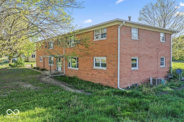 3200 Raible Ave, Anderson, IN 46011 - view of side of property with a yard, brick siding, and central AC
