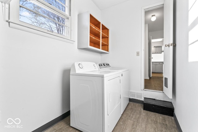 3200 Raible Ave, Anderson, IN 46011 - clothes washing area with wood finished floors, laundry area, washer and clothes dryer, visible vents, and baseboards