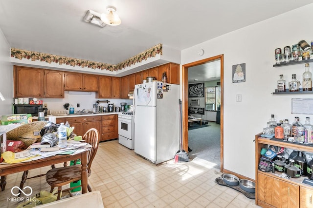3200 Raible Ave, Anderson, IN 46011 - kitchen with brown cabinetry, light floors, visible vents, white appliances, and light countertops