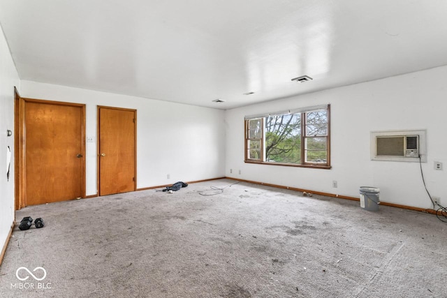 3200 Raible Ave, Anderson, IN 46011 - unfurnished room featuring baseboards, a wall mounted AC, and carpet