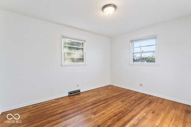 3200 Raible Ave, Anderson, IN 46011 - spare room with baseboards, visible vents, plenty of natural light, and wood finished floors
