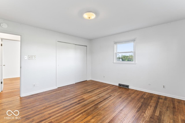 3200 Raible Ave, Anderson, IN 46011 - unfurnished bedroom featuring baseboards, a closet, visible vents, and wood finished floors