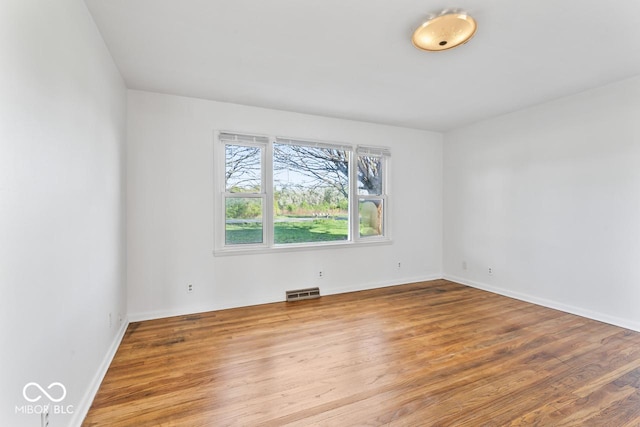 3200 Raible Ave, Anderson, IN 46011 - empty room with visible vents, wood finished floors, and baseboards