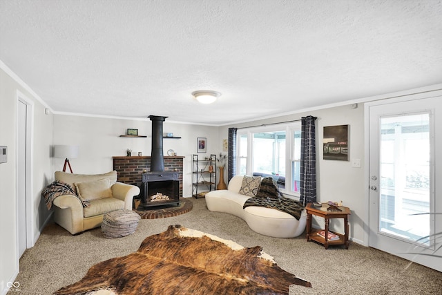carpeted living area featuring baseboards, a wood stove, a textured ceiling, and ornamental molding