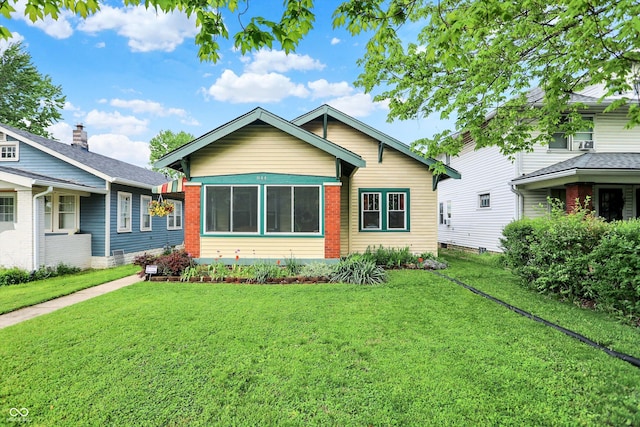 bungalow-style house with a front lawn