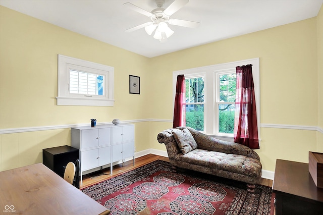 living area with plenty of natural light, ceiling fan, and wood finished floors
