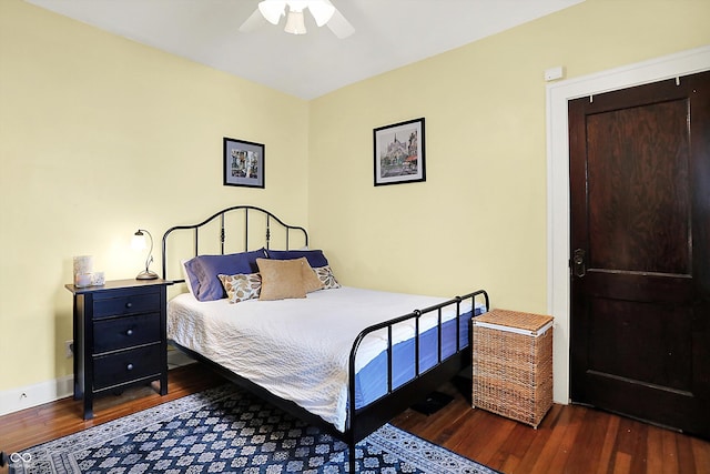 bedroom with wood finished floors, ceiling fan, and baseboards