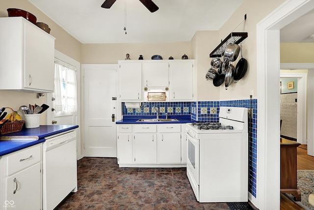 kitchen with white appliances, a sink, ceiling fan, white cabinetry, and dark countertops
