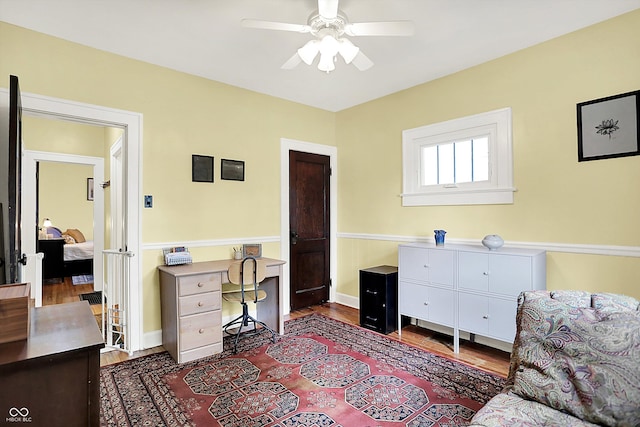 bedroom featuring a desk, dark wood-style flooring, and a ceiling fan