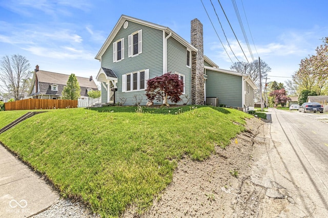 315 W High St, Pendleton, IN 46064 - view of home's exterior featuring a chimney and central AC