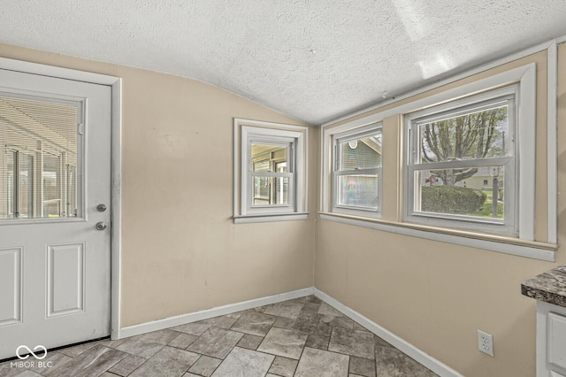 315 W High St, Pendleton, IN 46064 - entryway with a textured ceiling, baseboards, lofted ceiling, and stone finish floors