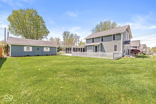315 W High St, Pendleton, IN 46064 - rear view of property featuring a sunroom, a lawn, and roof with shingles