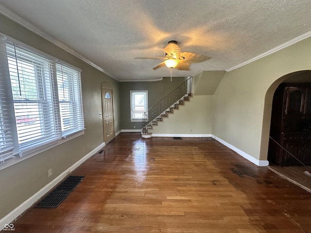315 W High St, Pendleton, IN 46064 - entrance foyer with a textured ceiling, wood finished floors, arched walkways, baseboards, and crown molding