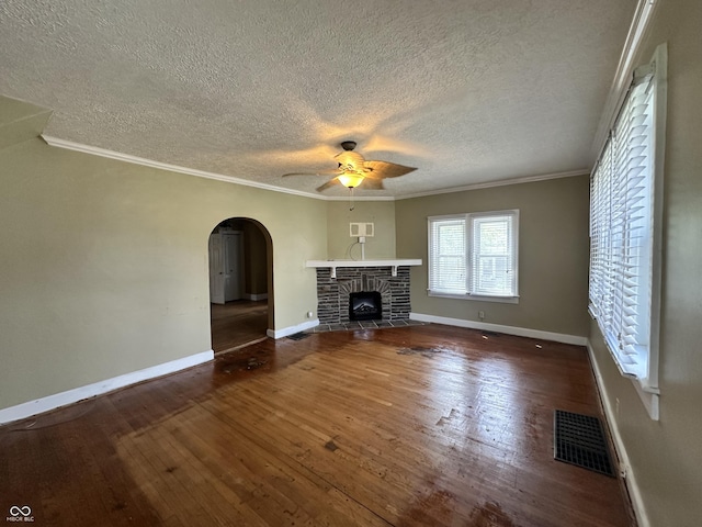 315 W High St, Pendleton, IN 46064 - unfurnished living room with ceiling fan, a textured ceiling, arched walkways, hardwood / wood-style flooring, and ornamental molding