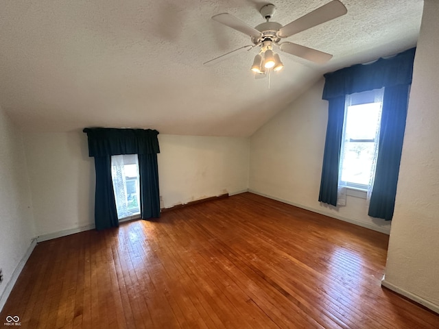 315 W High St, Pendleton, IN 46064 - additional living space with a textured ceiling, lofted ceiling, hardwood / wood-style flooring, a ceiling fan, and baseboards