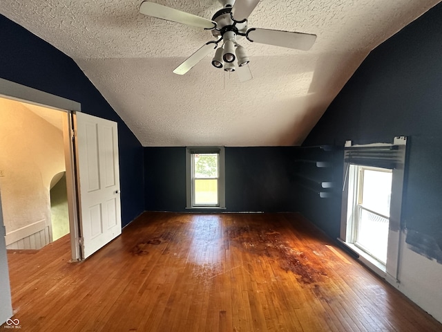 315 W High St, Pendleton, IN 46064 - unfurnished room featuring a textured ceiling, wood-type flooring, lofted ceiling, a ceiling fan, and arched walkways