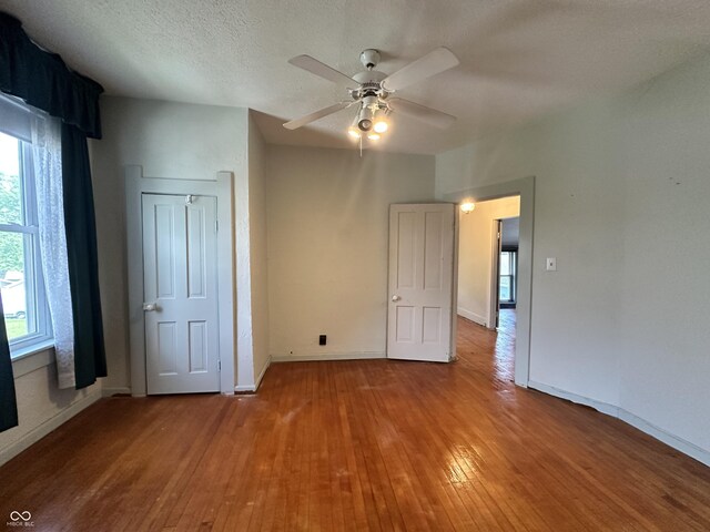 315 W High St, Pendleton, IN 46064 - unfurnished bedroom featuring hardwood / wood-style flooring, baseboards, and a ceiling fan