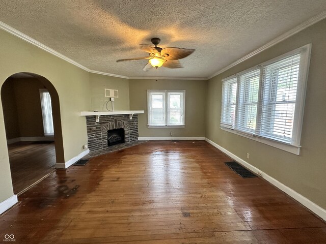 315 W High St, Pendleton, IN 46064 - unfurnished living room with ceiling fan, arched walkways, wood-type flooring, a textured ceiling, and a fireplace
