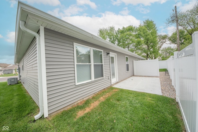 back of house featuring a yard, fence, a patio area, and central AC