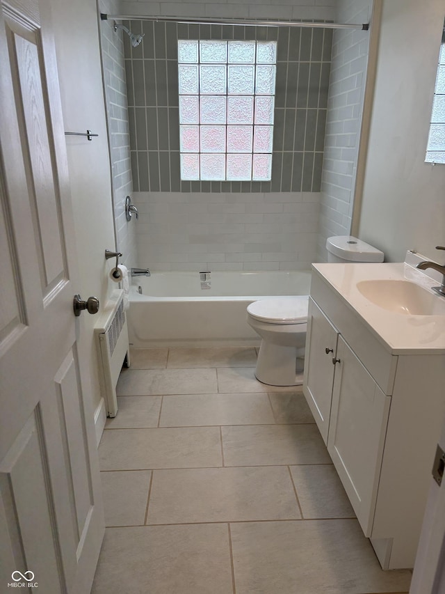 full bathroom with shower / bathing tub combination, tile patterned floors, vanity, toilet, and radiator heating unit