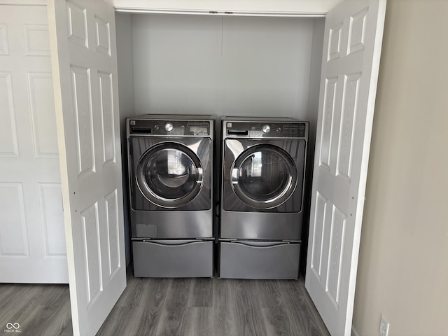 laundry room with separate washer and dryer and wood finished floors
